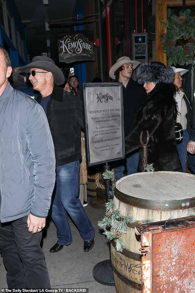 Его наряд состоял из черной куртки поверх темно-синей рубашки и синих джинсов.